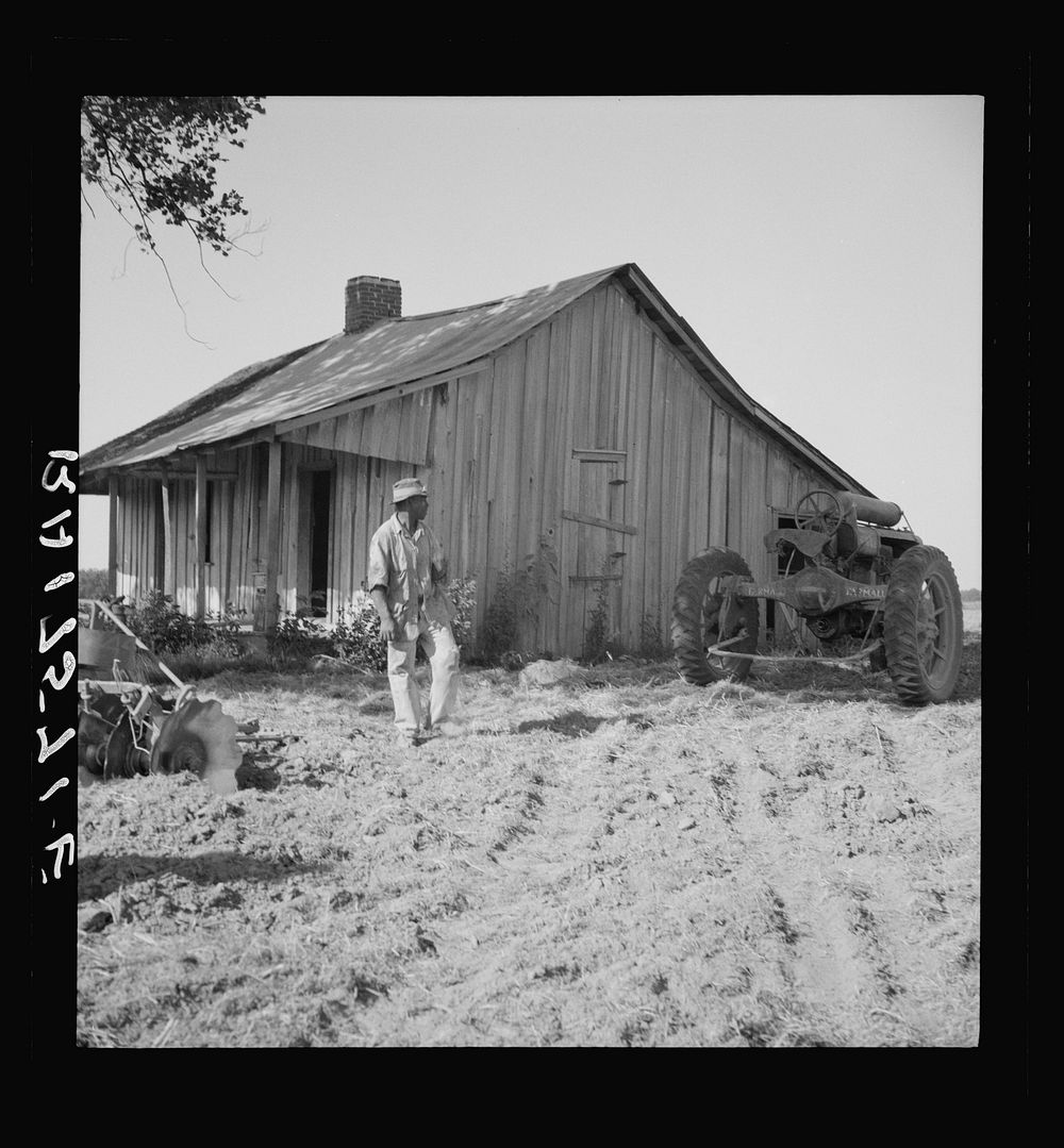 Colored tractor driver and empty cabin on mechanized cotton plantation.  Aldridge Plantation near Leland, Mississippi.…