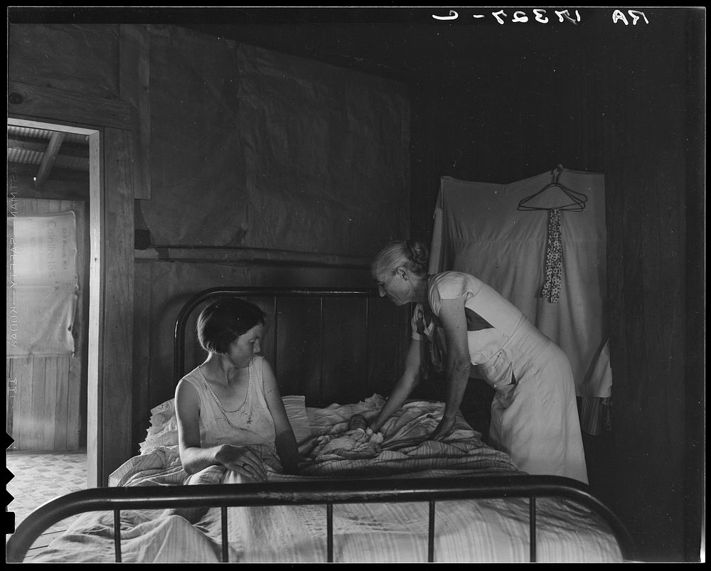 Grandmother, mother, and new born baby of a sharecropper family near Cleveland, Mississippi by Dorothea Lange