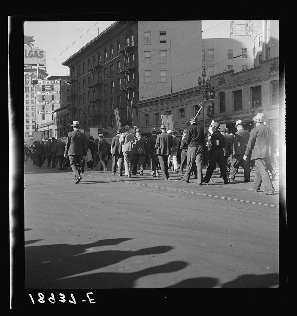 Mass meeting of Works Progress Administration (WPA) workers parading up Market Street, San Francisco, California. The…
