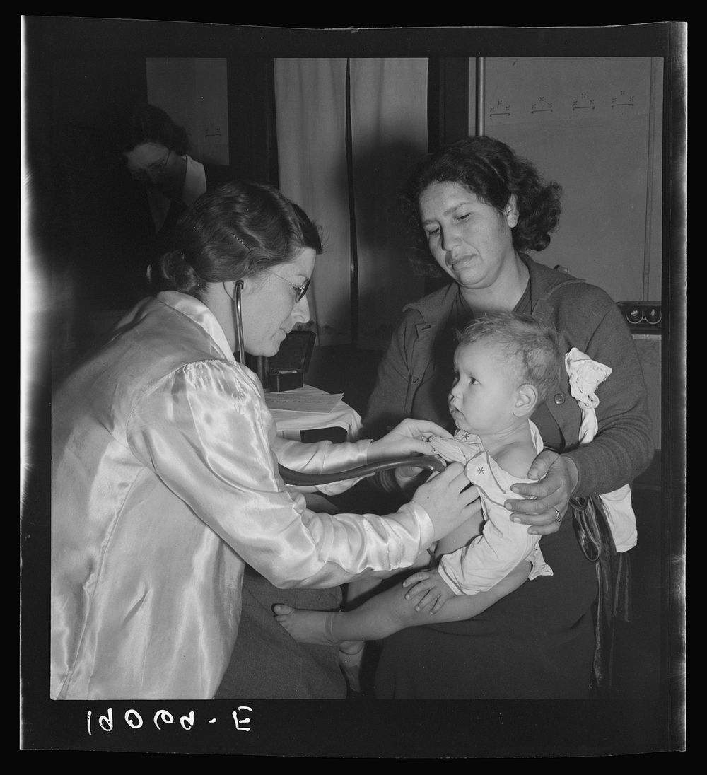 Calipatria, Imperial Valley. Visiting public health doctor conducts well-baby clinic in local school building adjacent to…