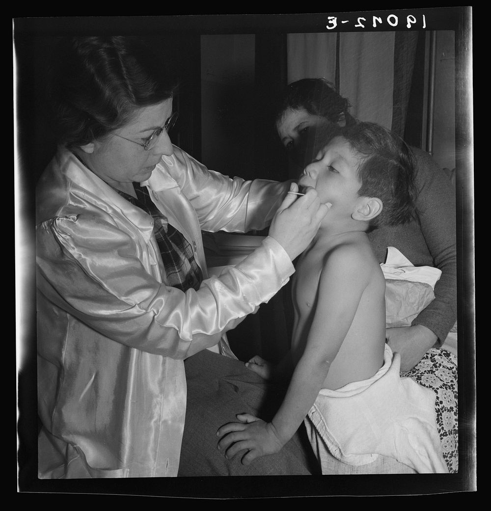 Calipatria, Imperial Valley. Visiting public health doctor conducts well-baby clinic in local school building adjacent to…