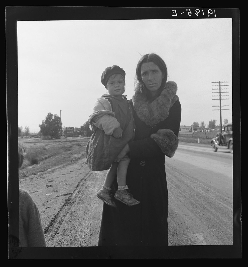 On U.S. 99. Near Brawley, Imperial County. Homeless mother and youngest child of seven walking the highway from Phoenix…