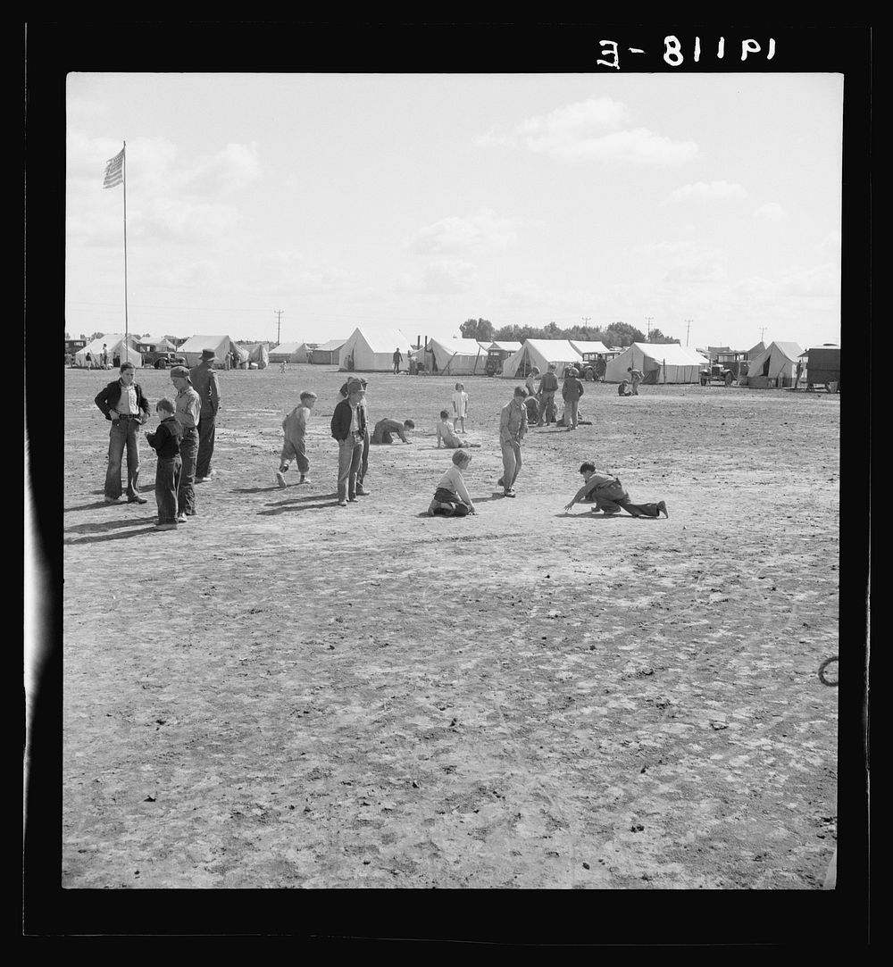 [Untitled photo, possibly related to: Marble time in Farm Security Administration (FSA) migratory labor camp (emergency.)…