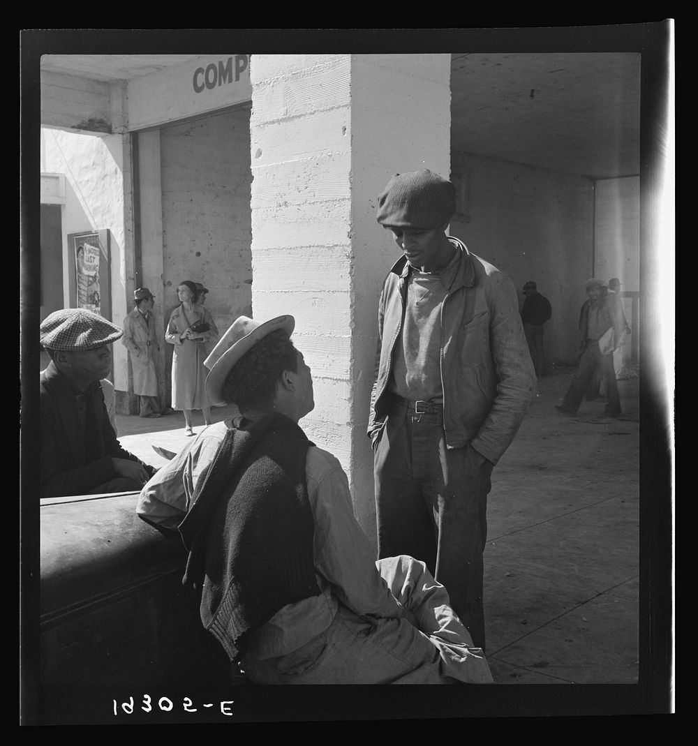 Outside the Farm Security Administration (FSA) grant office during the pea harvest. Calipatria, California. During spring of…