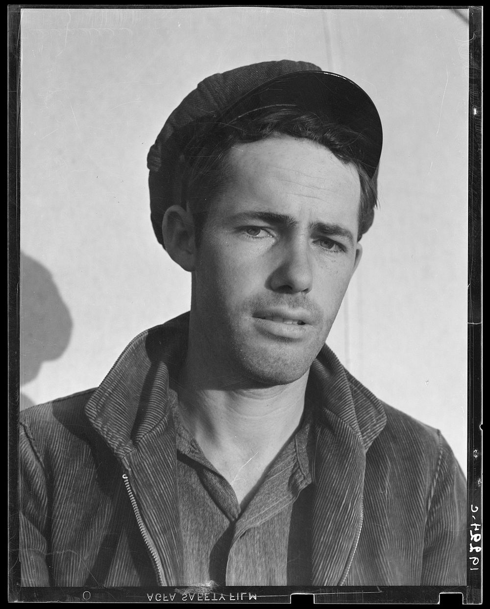 Son-in law of migratory family in Farm Security Administration (FSA) labor camp. Calipatria, Imperial Valley, California.…