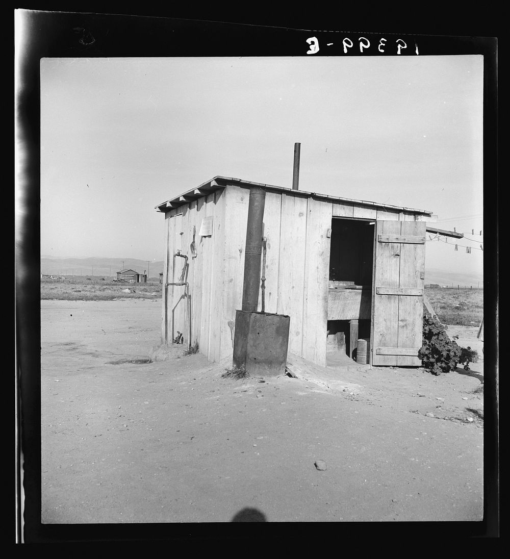 Laundry facilities for ten cabins at Arkansawyers auto camp, Salinas Valley, California. Note stove to heat water. Sourced…