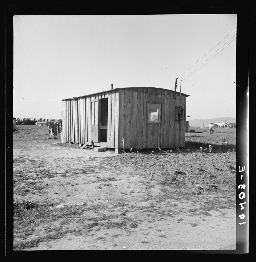 Housing for rapidly growing settlement of lettuce workers on fringe of town, Salinas, California. These houses are built by…