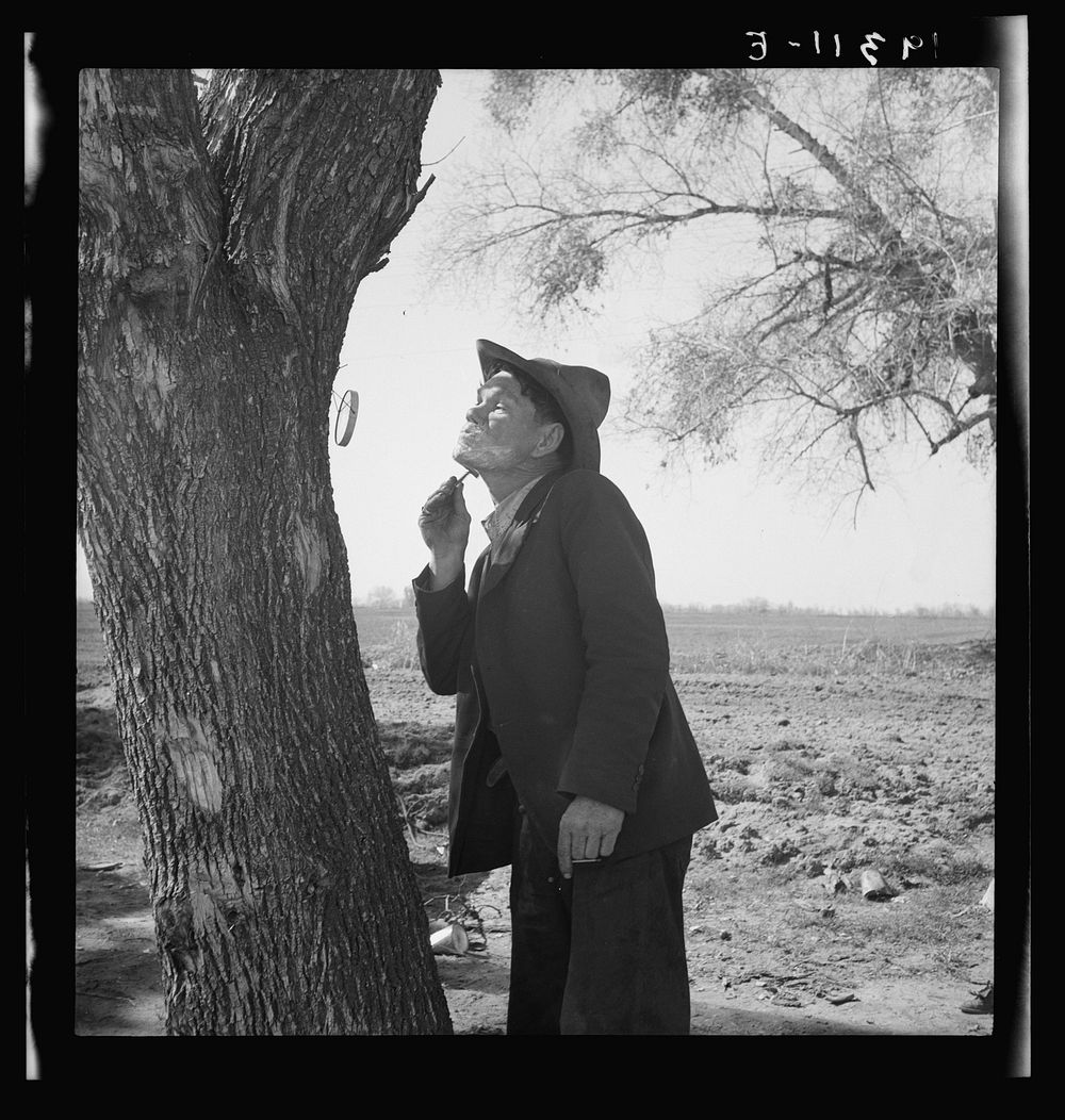 On U.S. 99 between Bakersfield and the Ridge, en route to San Diego. Migrant man shaving by roadside. See general caption…