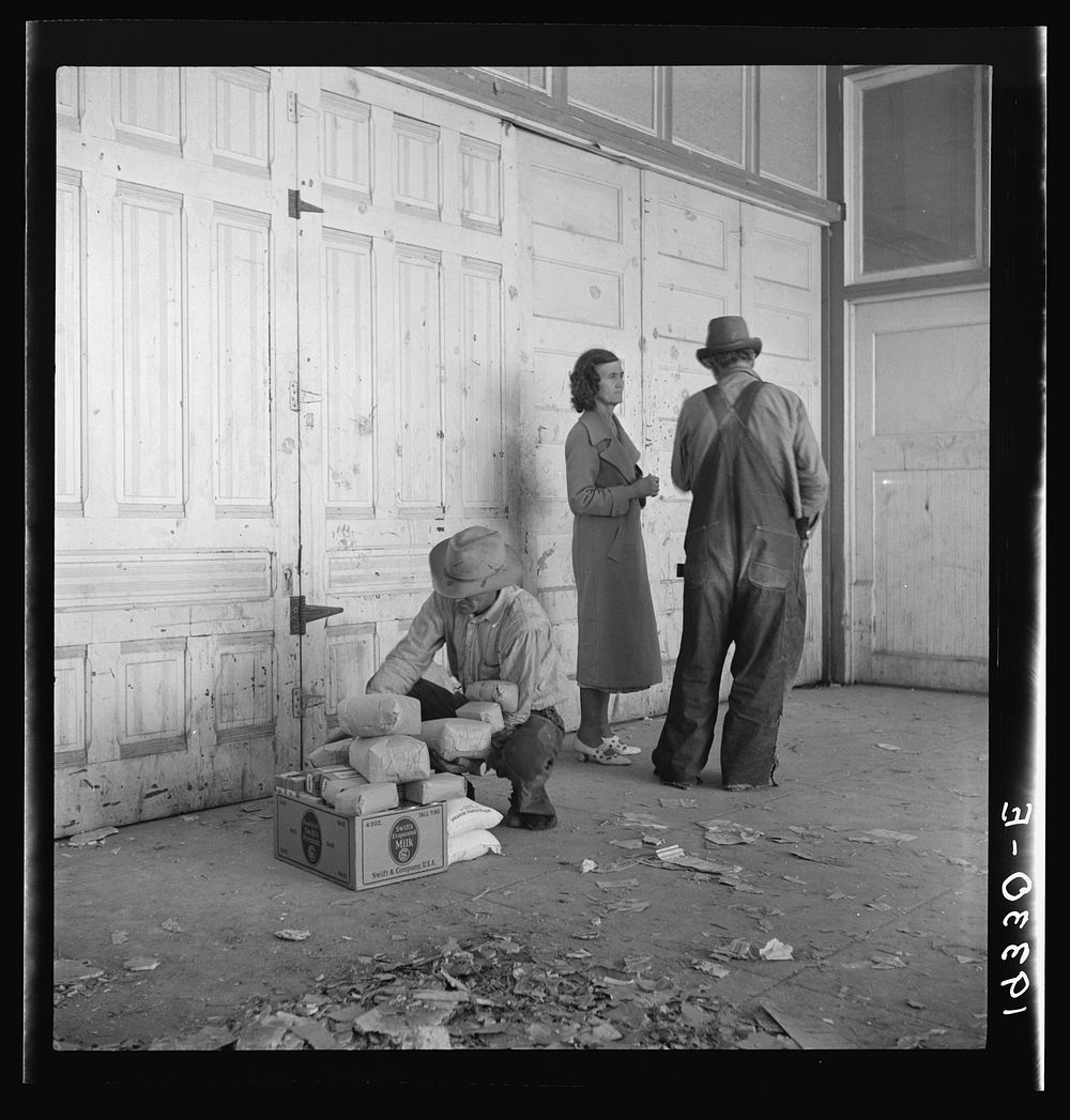 Outside the Farm Security Administration (FSA) grant office during pea harvest. Calipatria, California. During the spring of…
