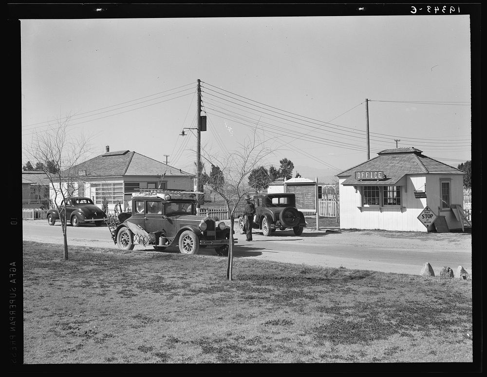 Entering Farm Security Administration (FSA) camp for migratory laborers at Indio. Coachella Valley, California. Sourced from…