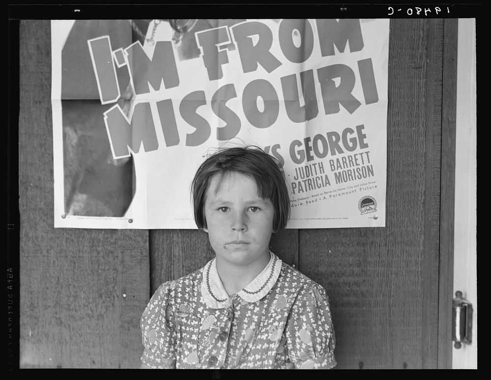 Advertisement for current movie in town. The child is a flood refugee of March 1938 from southeast Missouri. Westley…