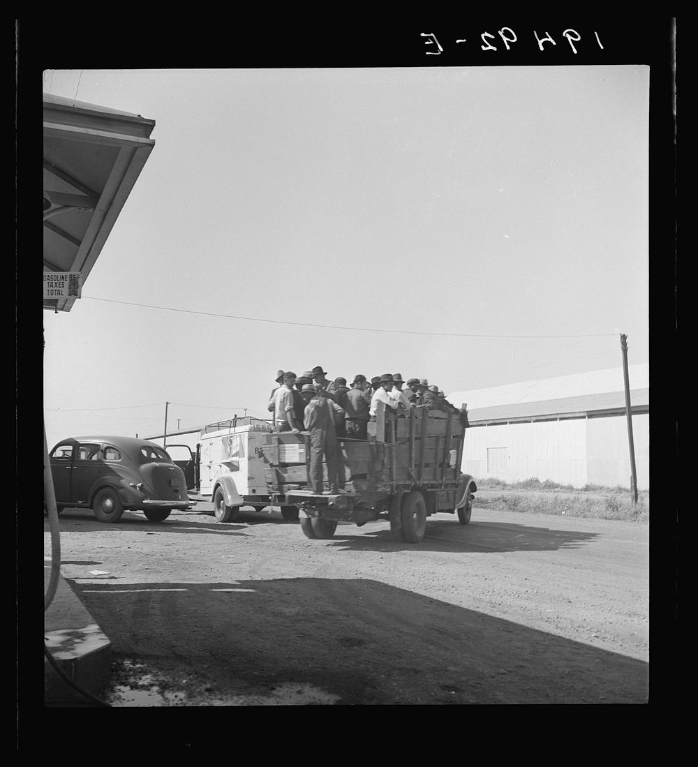 Labor contractor's truck with gang of pea pickers, pulled up for gas. Near Westley, California. Sourced from the Library of…