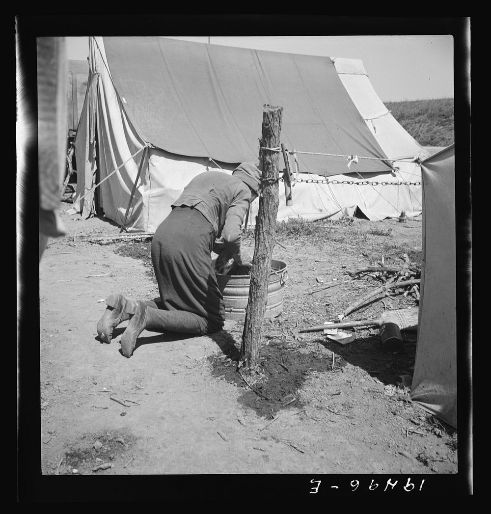 A grandmother washing clothes in California. In a contractor's camp near Westley, California. Sourced from the Library of…