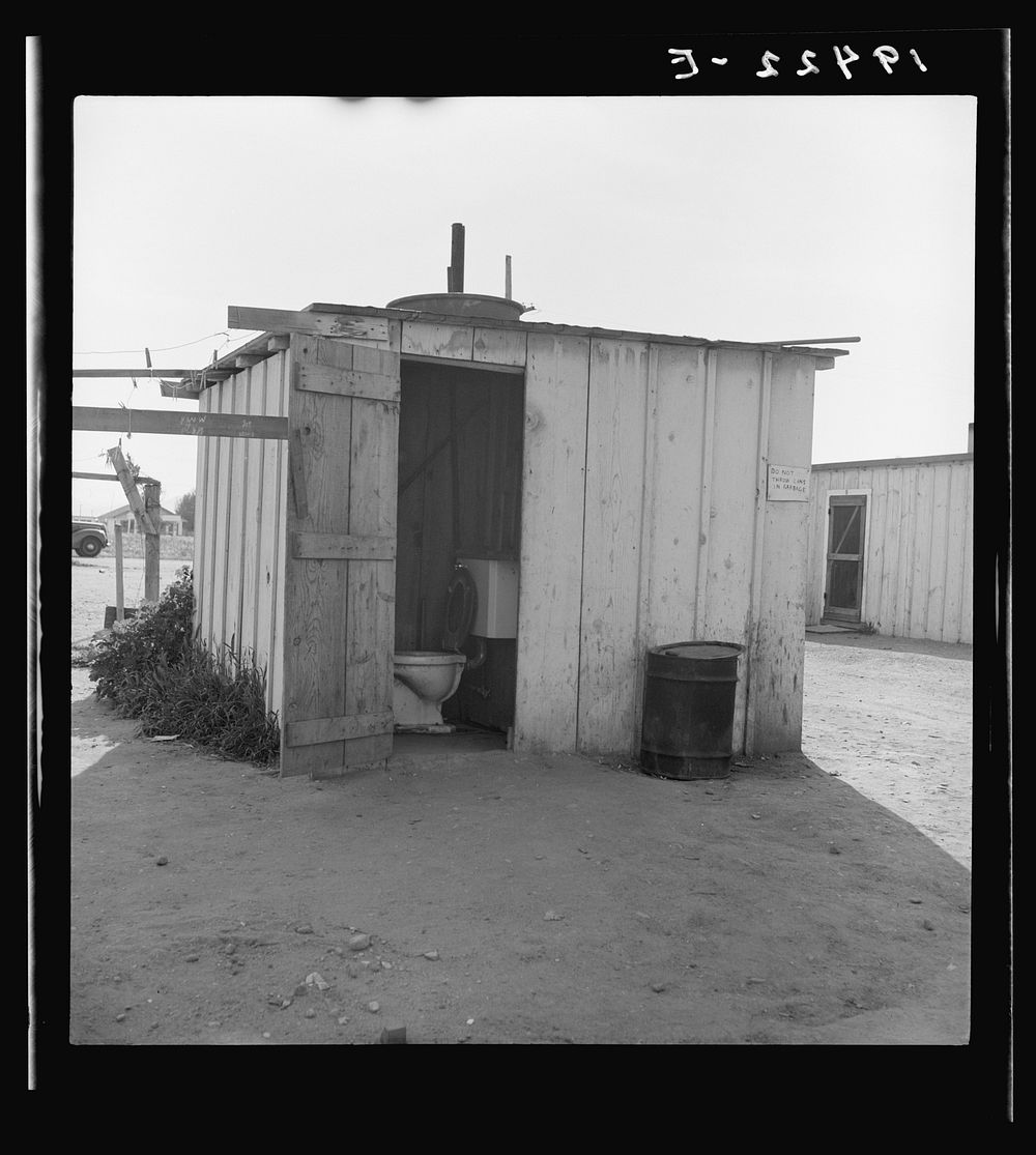 Toilet for ten cabins, men, women, and children. In Arkansawyers auto camp. Greenfield, California. Sourced from the Library…