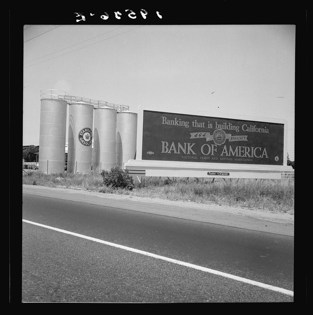 Between Tulare and Fresno on U.S. 99. Highway gas tanks and signboard approaching town. See general caption. Sourced from…