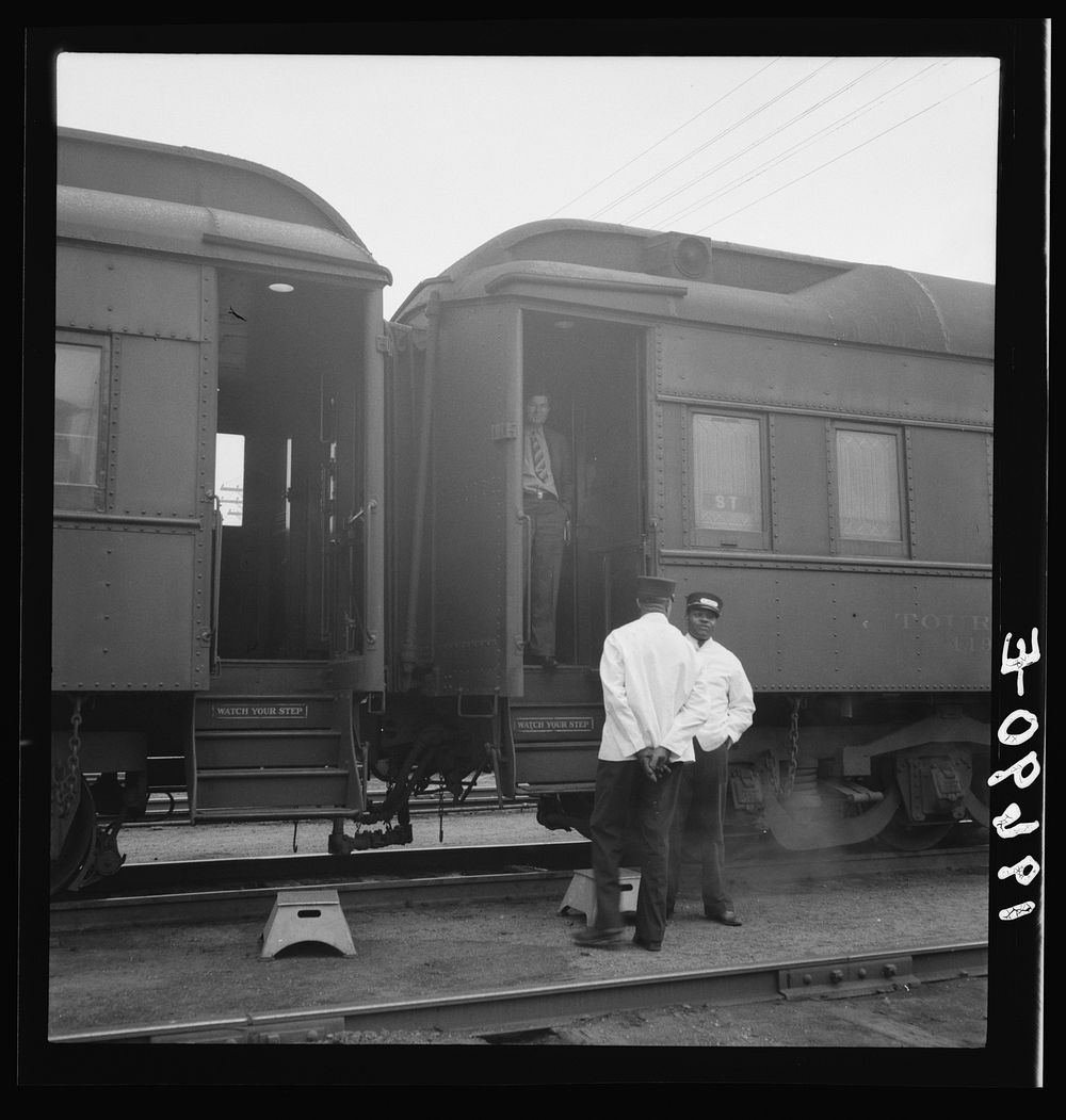 [Untitled photo, possibly related to: Railroad yards, Kearney, Nebraska. Overland train passengers go back to their cars…