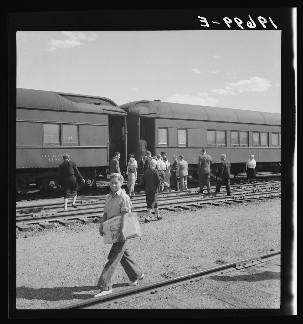 [Untitled photo, possibly related to: Railroad yards, Kearney, Nebraska. Overland train passengers go back to their cars…