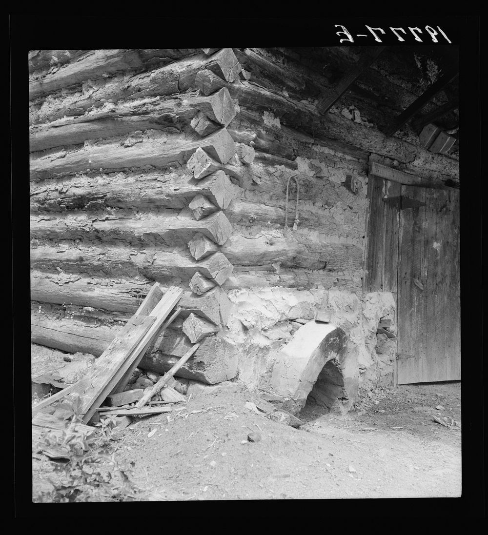 Detail of tobacco barn showing log construction and newly plastered furnace in preparation for "putting in". Person County…