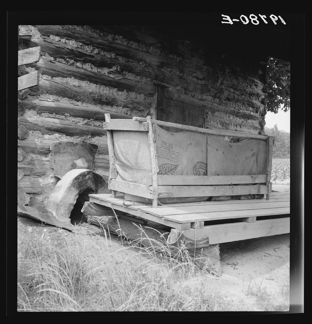 Tobacco barn with tobacco sled and vehicle used for conveying tobacco sleds. Person County, North Carolina. Sourced from the…