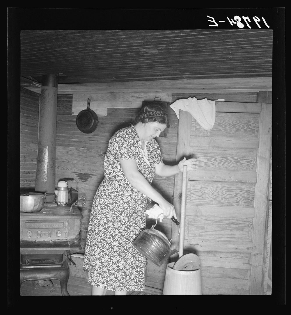 Wife of tobacco sharecropper cleaning butter churn. Person County, North Carolina. Sourced from the Library of Congress.