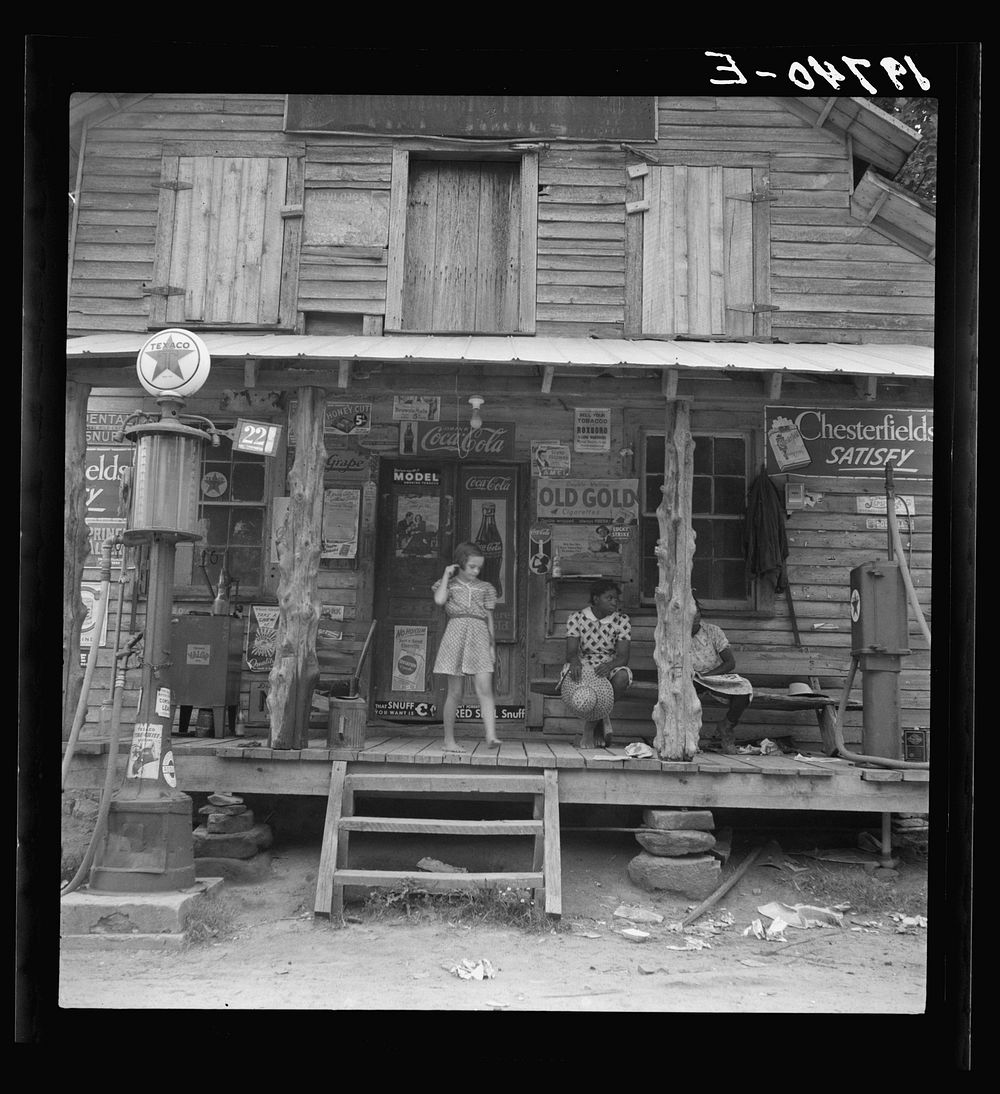 Daughter of white tobacco sharecropper at country store. Person County, North Carolina by Dorothea Lange