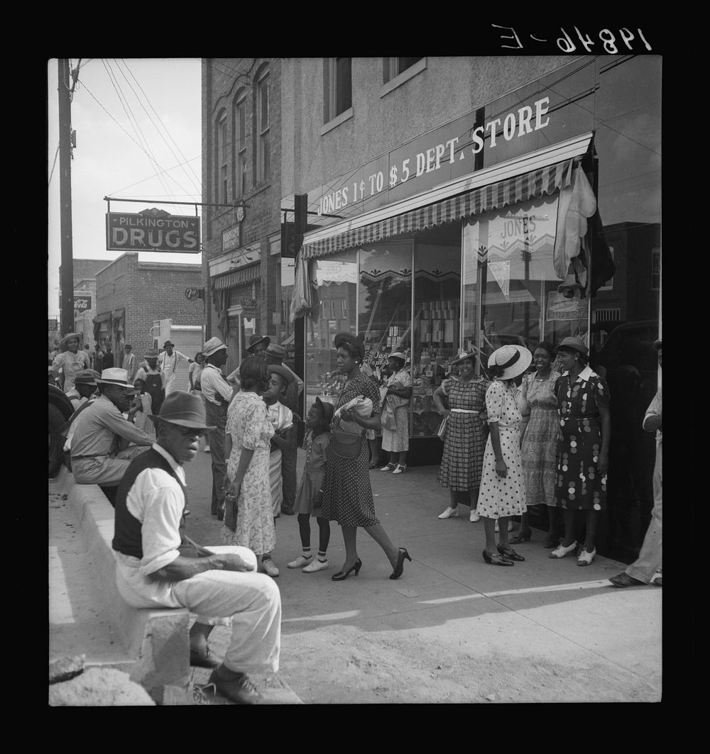 Shopping and visiting on main street of Pittsboro, North Carolina. Saturday afternoon. Sourced from the Library of Congress.