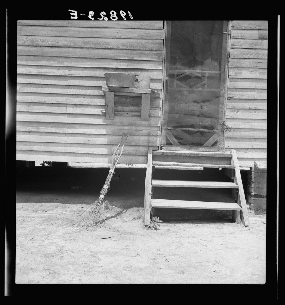 Kitchen door of Zollie Lyon's house. Note brushbroom. Wake County, North Carolina. Sourced from the Library of Congress.