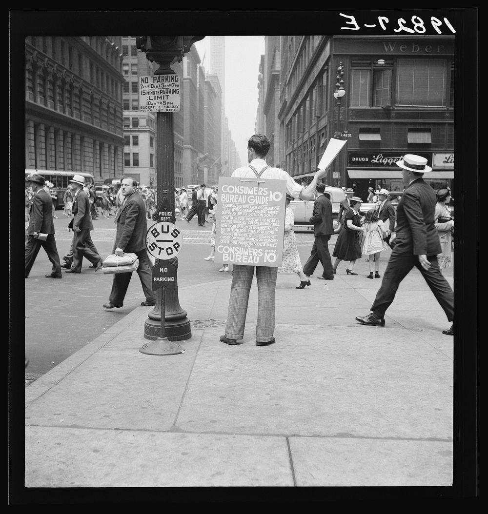 42nd Street and Madison Avenue. Street hawker selling Consumer's Bureau Guide. New York City. Sourced from the Library of…