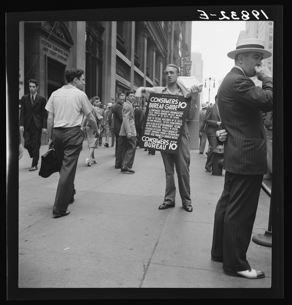[Untitled photo, possibly related to: 42nd Street and Madison Avenue. Street hawker selling Consumer's Bureau Guide. New…
