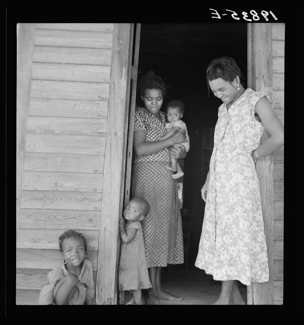 Two tobacco tenant mothers (related) with part of their children. Wake County, North Carolina. Sourced from the Library of…