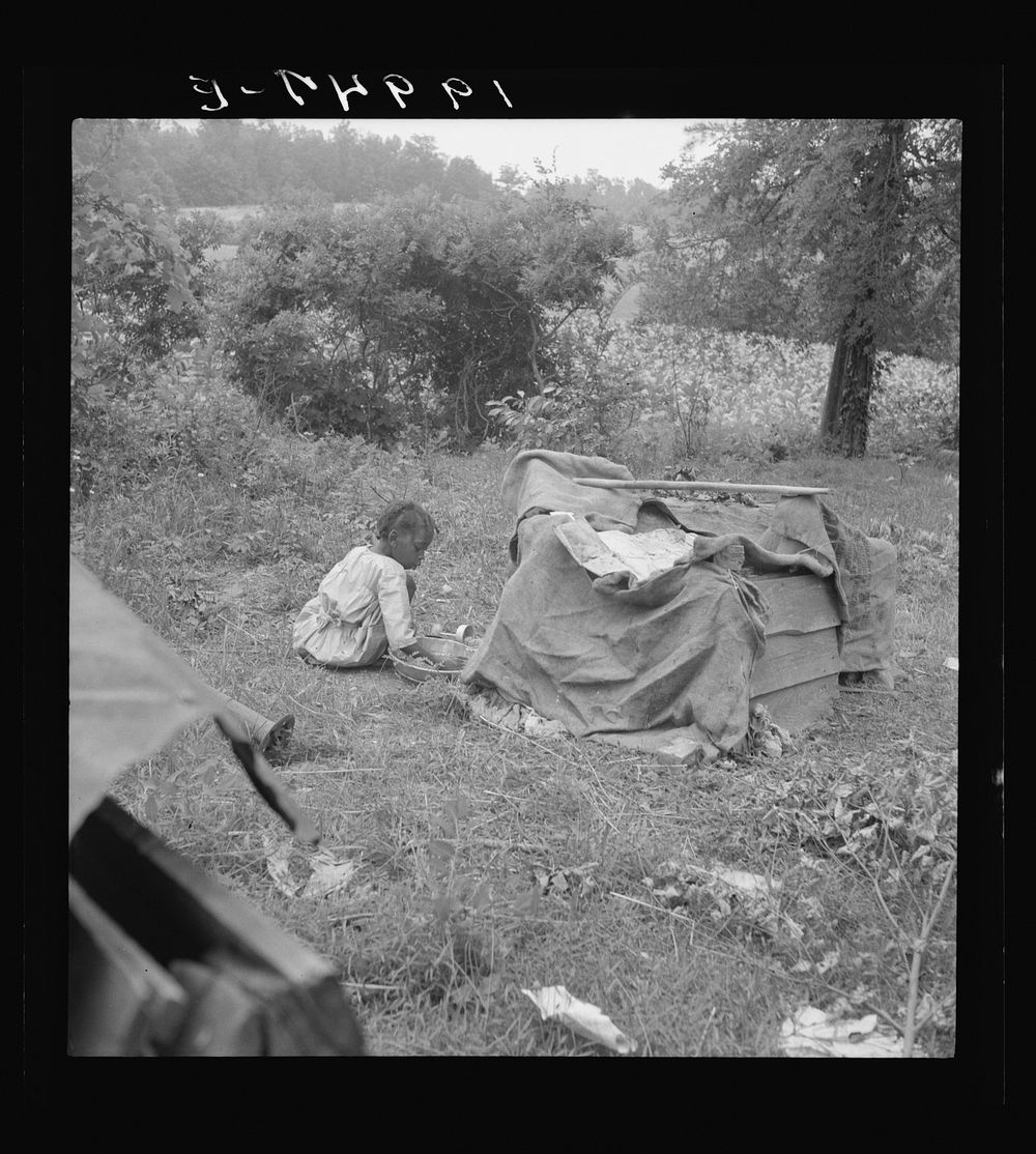 Tobacco sharecropper child playing. Note burlap covered playhouse. Person County, North Carolina. Sourced from the Library…