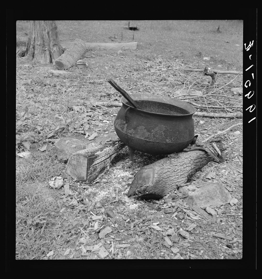 Iron pot for heating water stands out in the yard of  tobacco farmer. Person County, North Carolina. Sourced from the…