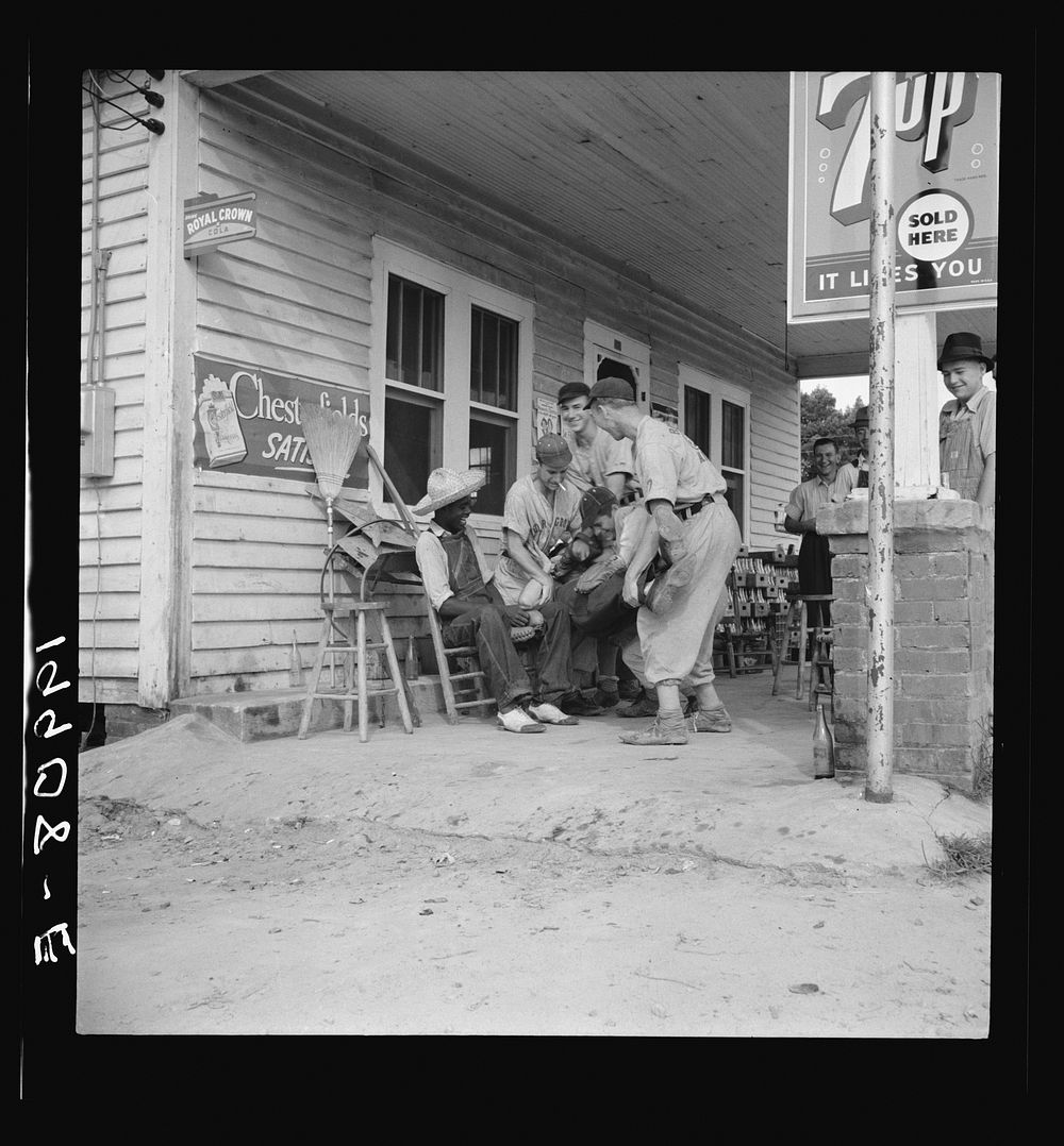 [Untitled photo, possibly related to: Rural filling station becomes community center and general grounds for loafing. The…