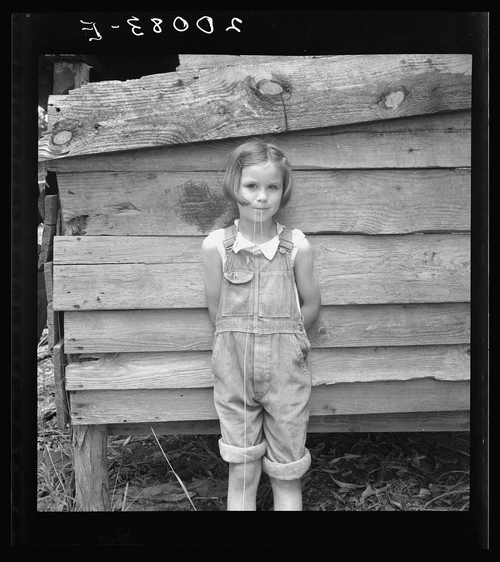 Eight year old daughter who helps about the tobacco barn and takes care of the baby. Granville County, North Carolina.…