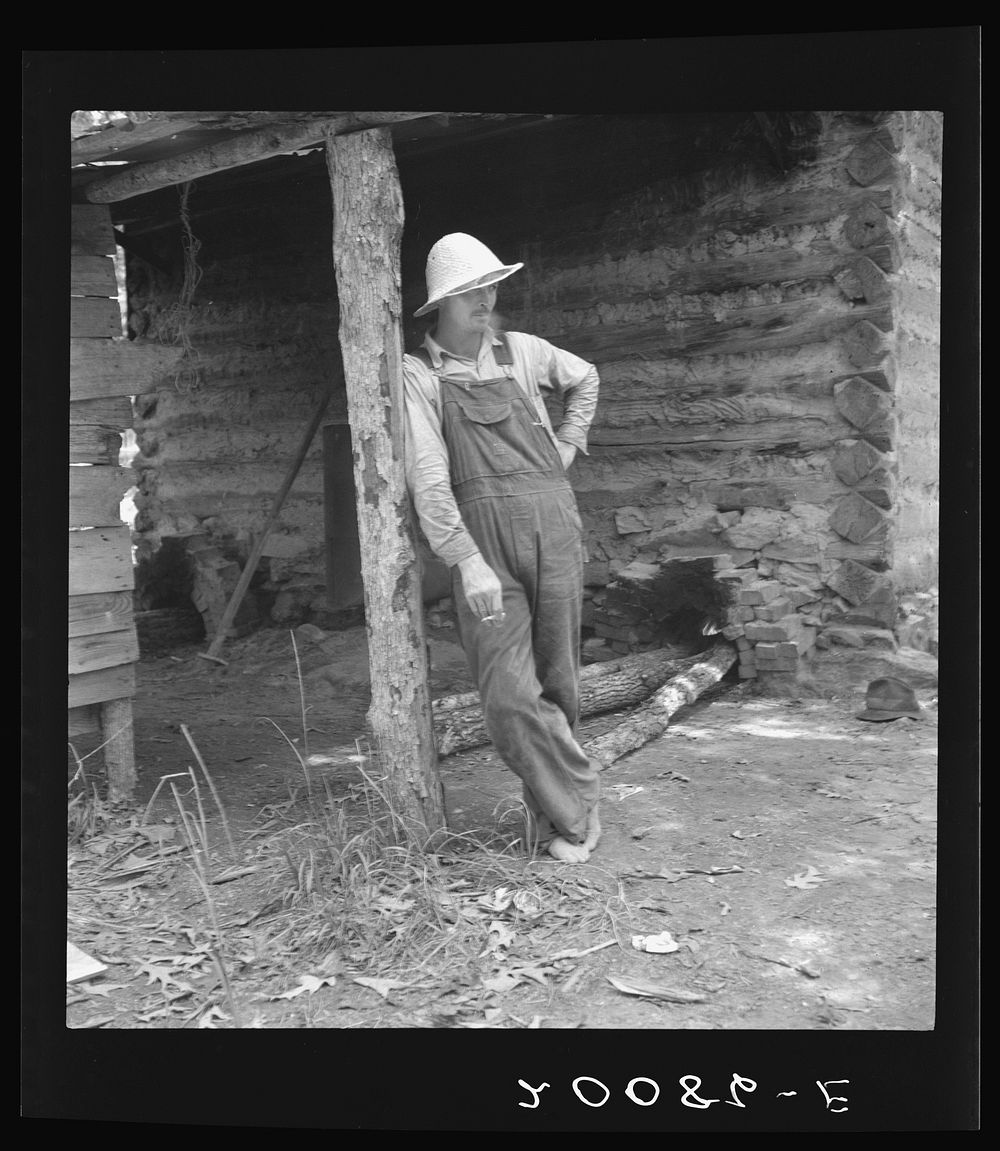Mr. Taylor, tobacco sharecropper, relaxes when the tobacco has been "put up." Granville County, North Carolina. Sourced from…