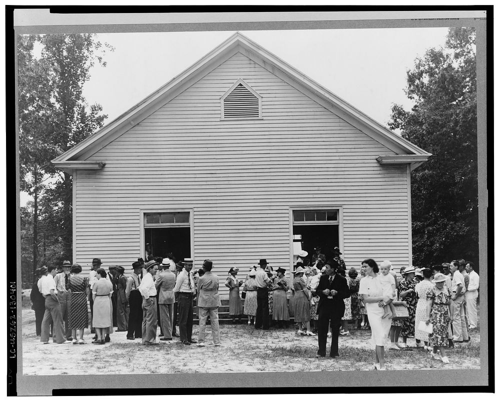 Congregation gathers in groups to talk after services are over. Wheeley's Church, Person County, North Carolina. Sourced…
