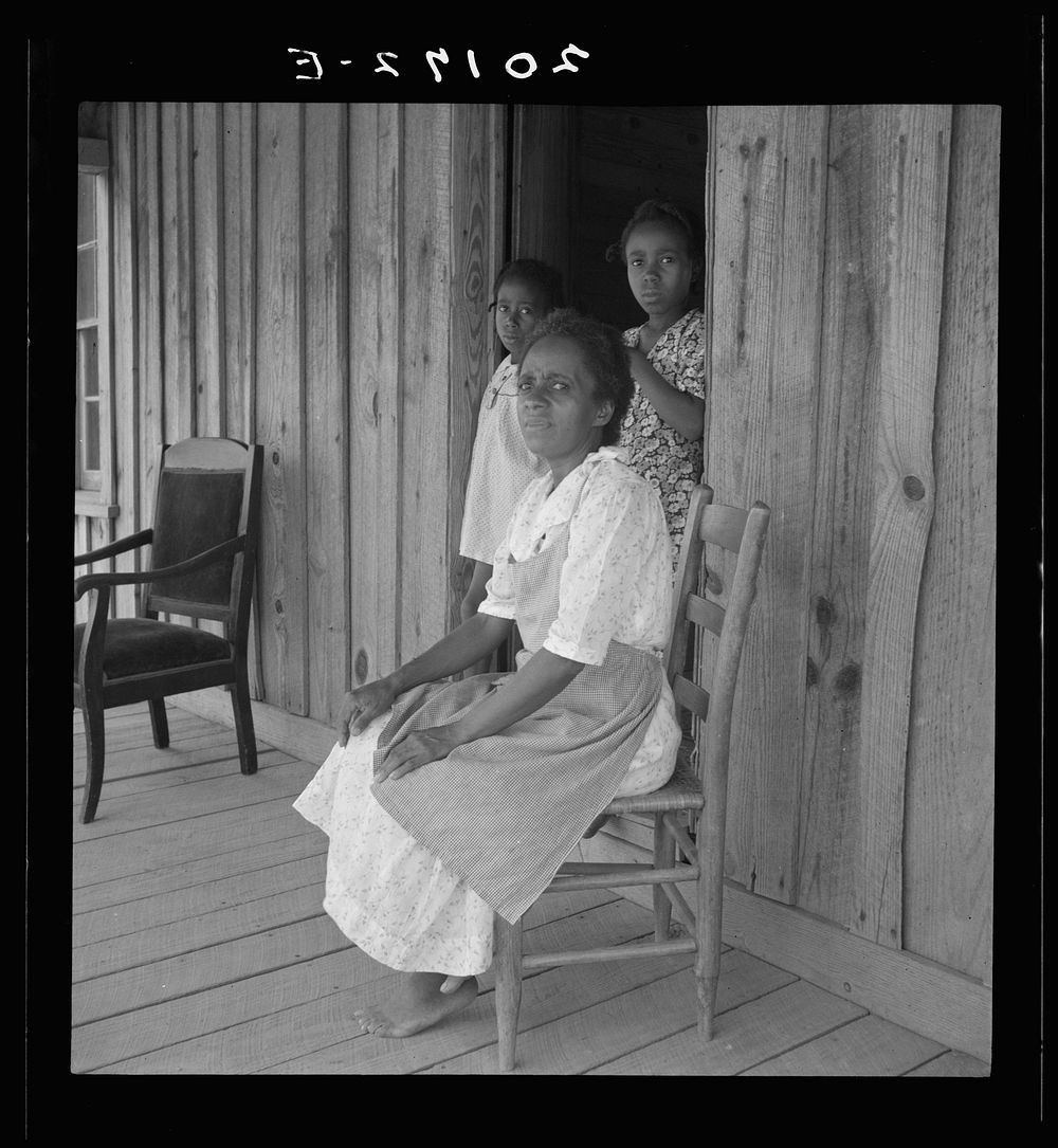 Wife of tenant farmer with two of her six children, none of whom go to school. Chatham County, North Carolina. Sourced from…