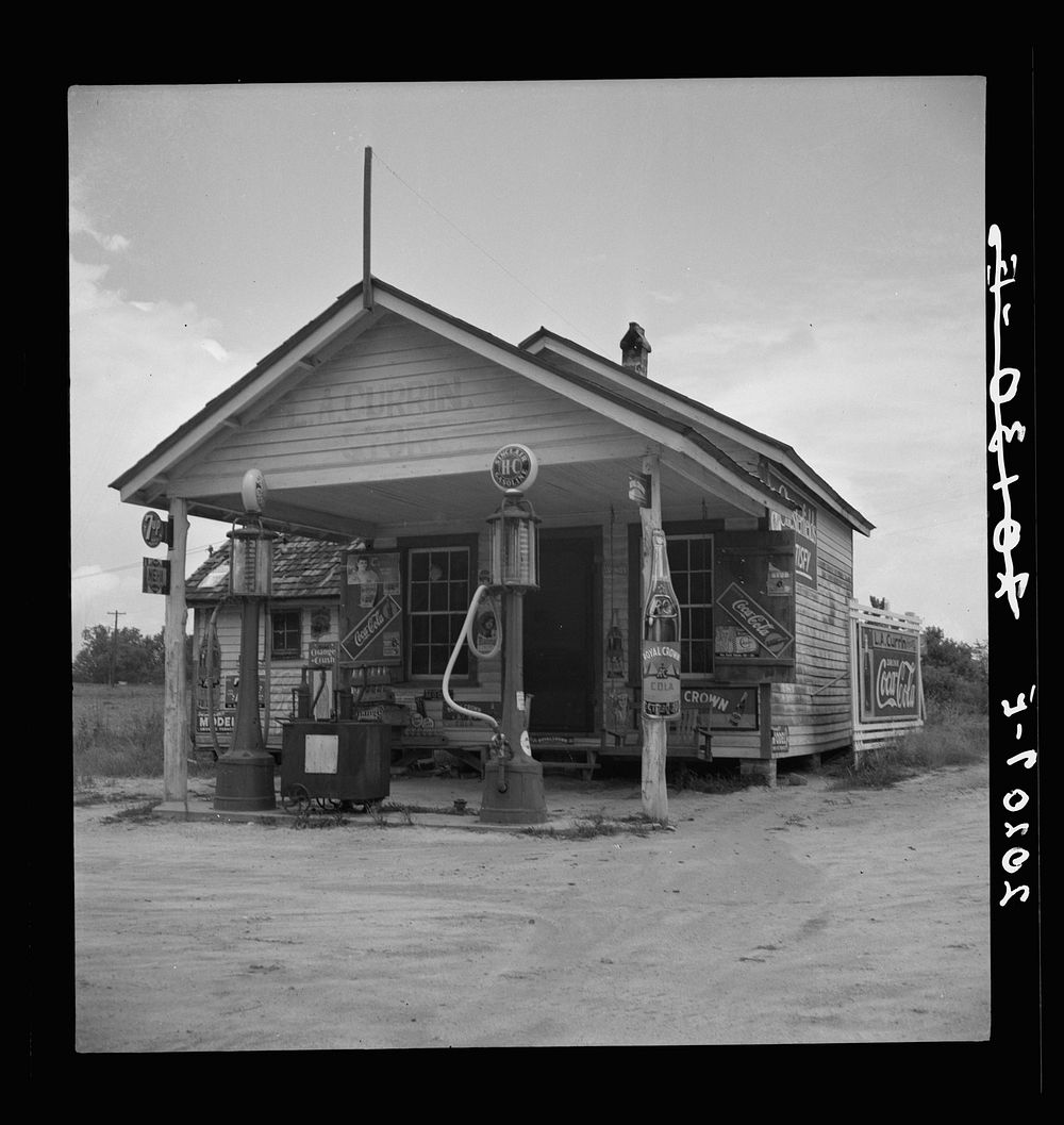 Country filling station owned and operated by tobacco farmer. Such small independent stations have become meeting places and…