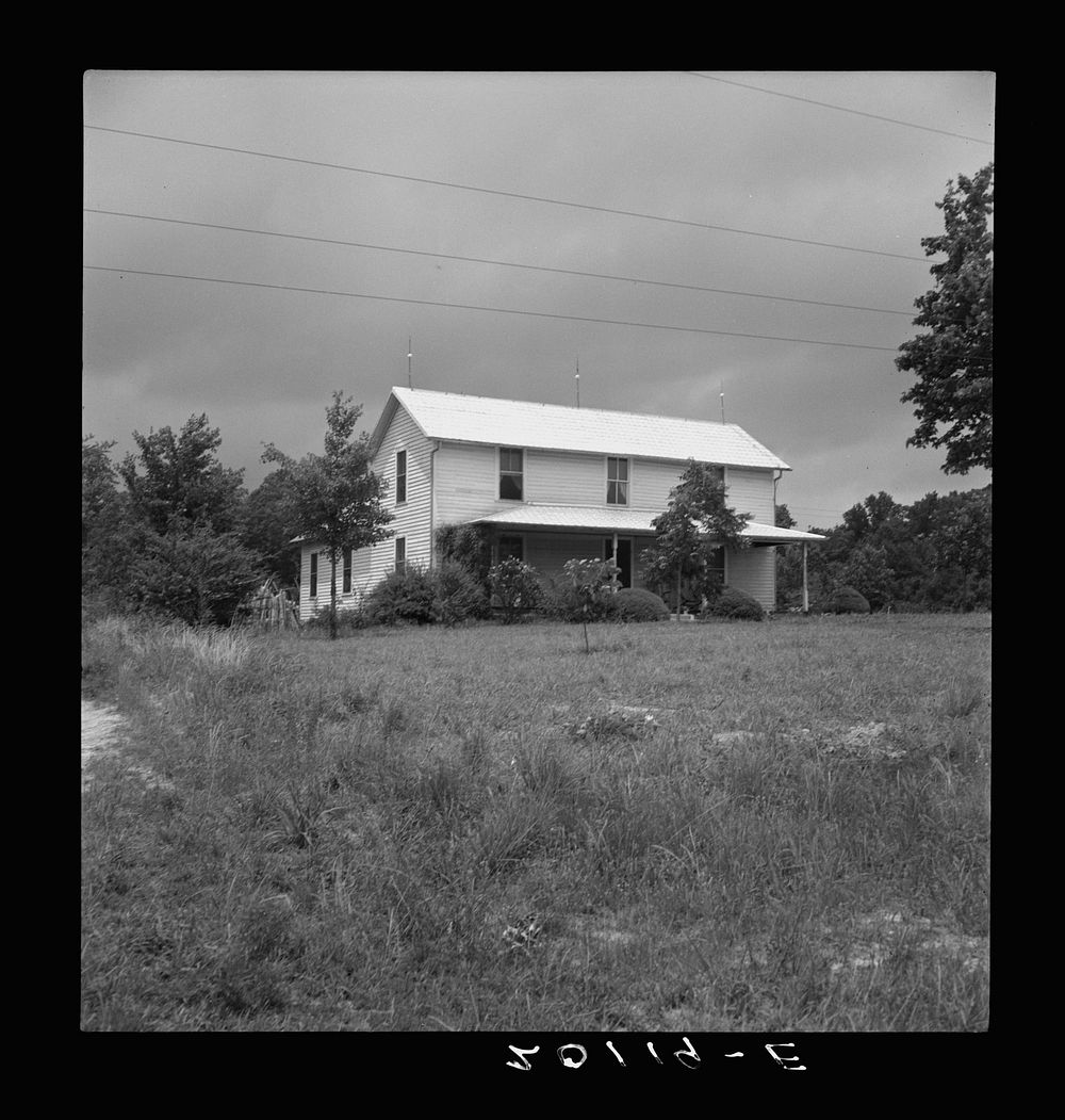 Substantial looking tobacco farm. Note galvanized imitation shingle roof. Person county, North Carolina. Sourced from the…