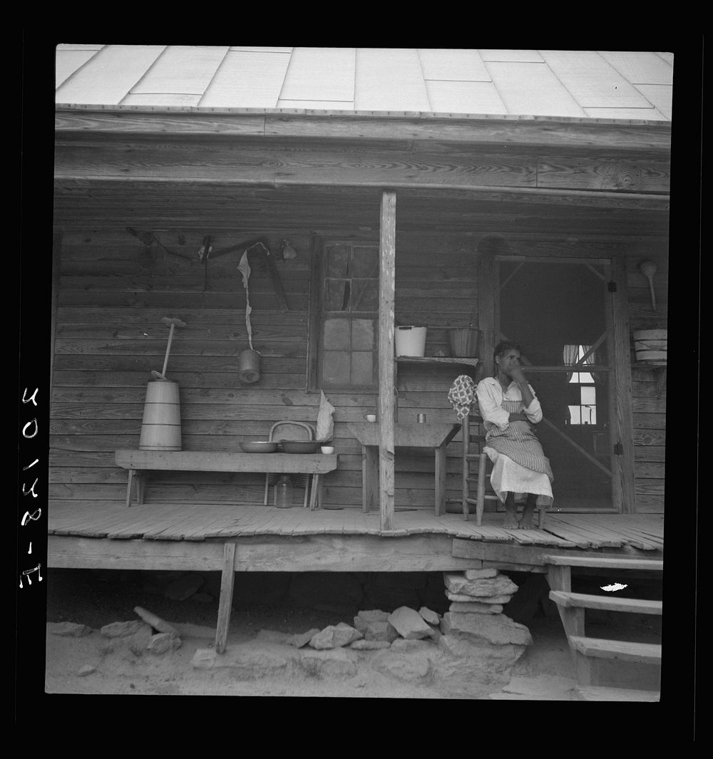 Porch of  tenant house, showing household equipment. Person County, North Carolina. Sourced from the Library of Congress.