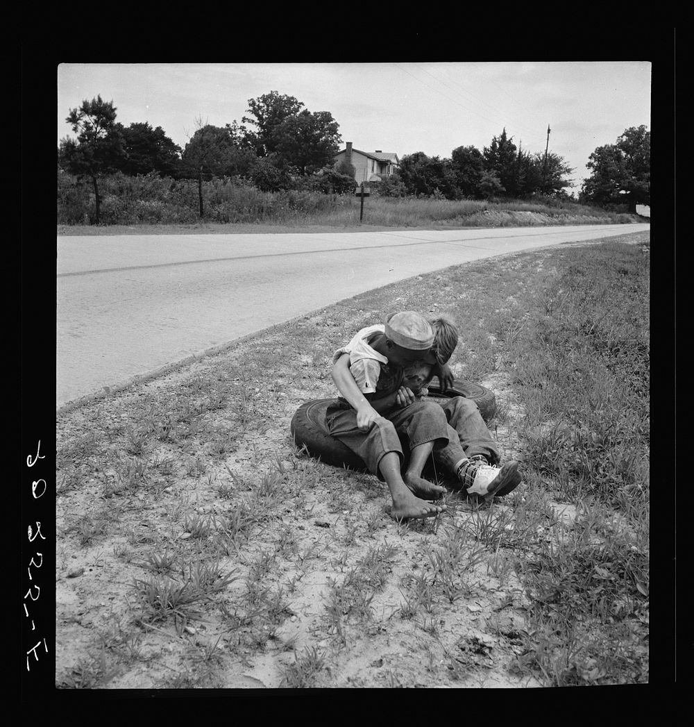 [Untitled photo, possibly related to: White and  boy wrestling by side of road. Person County, North Carolina]. Sourced from…