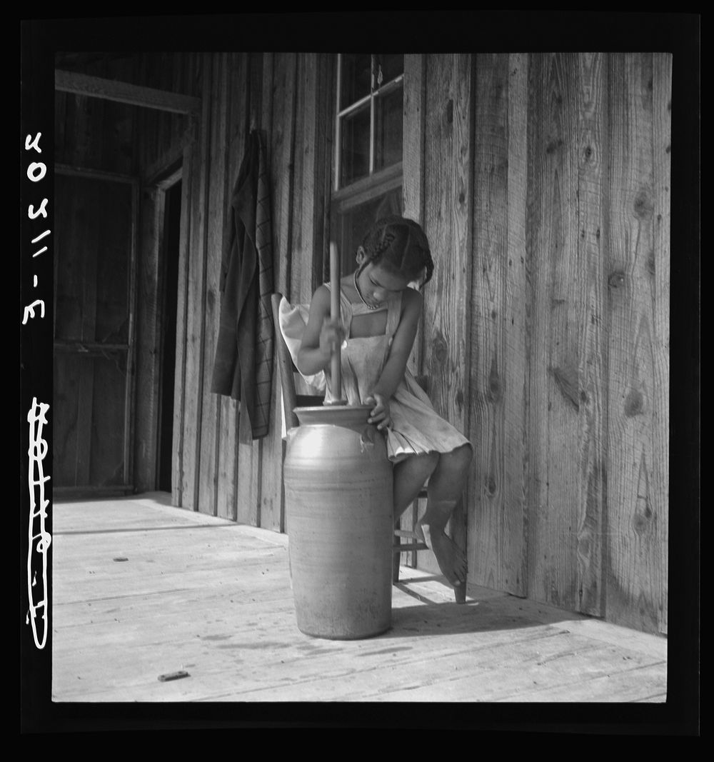 Daughter of  tenant churning butter. Randolph County, North Carolina. Sourced from the Library of Congress.
