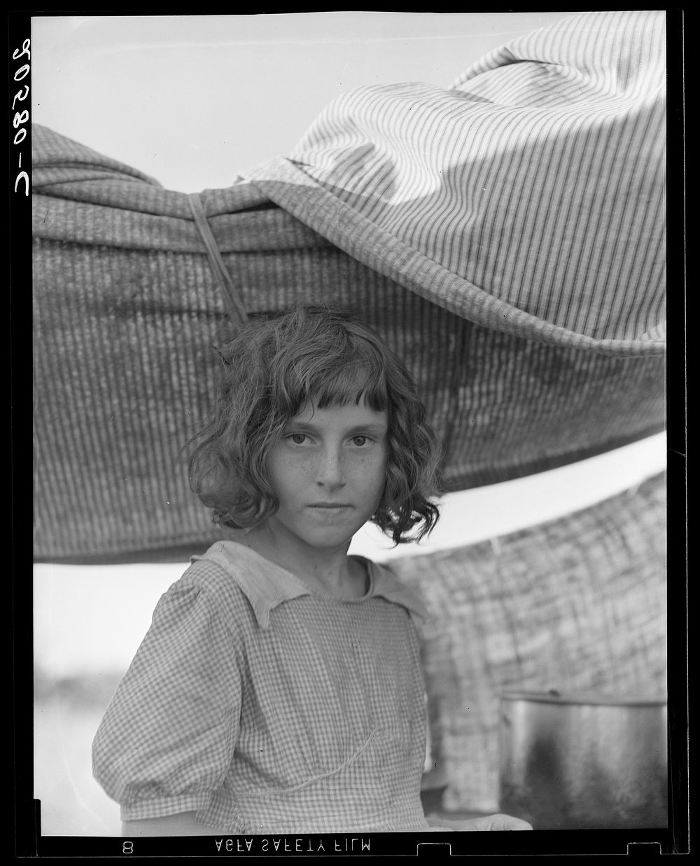 Migratory child in camp at end of day. Bean pickers' camp near West Stayton, Oregon. by Dorothea Lange