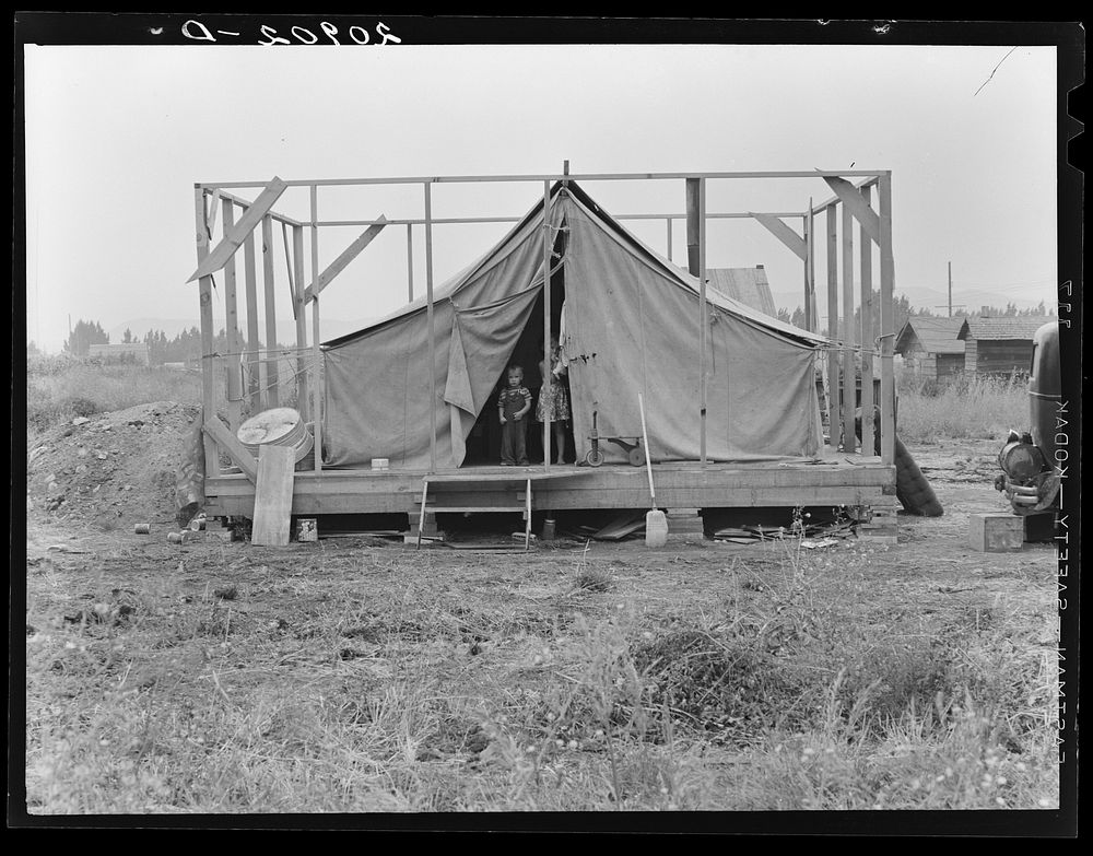 Family living in tent while building the house around them. Near Klamath Falls, Klamath County, Oregon. See general caption…