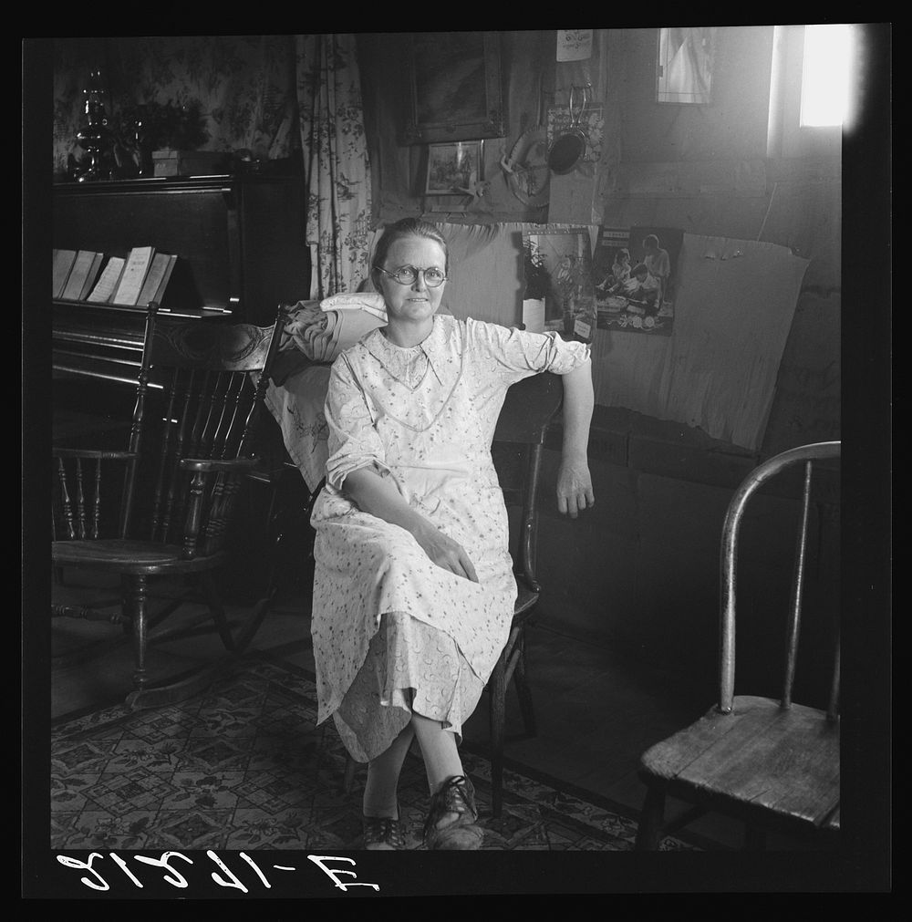 Mrs. Hull, in one room basement dugout home, late afternoon. Dead Ox Flat, Malheur County, Oregon. General caption number 67…