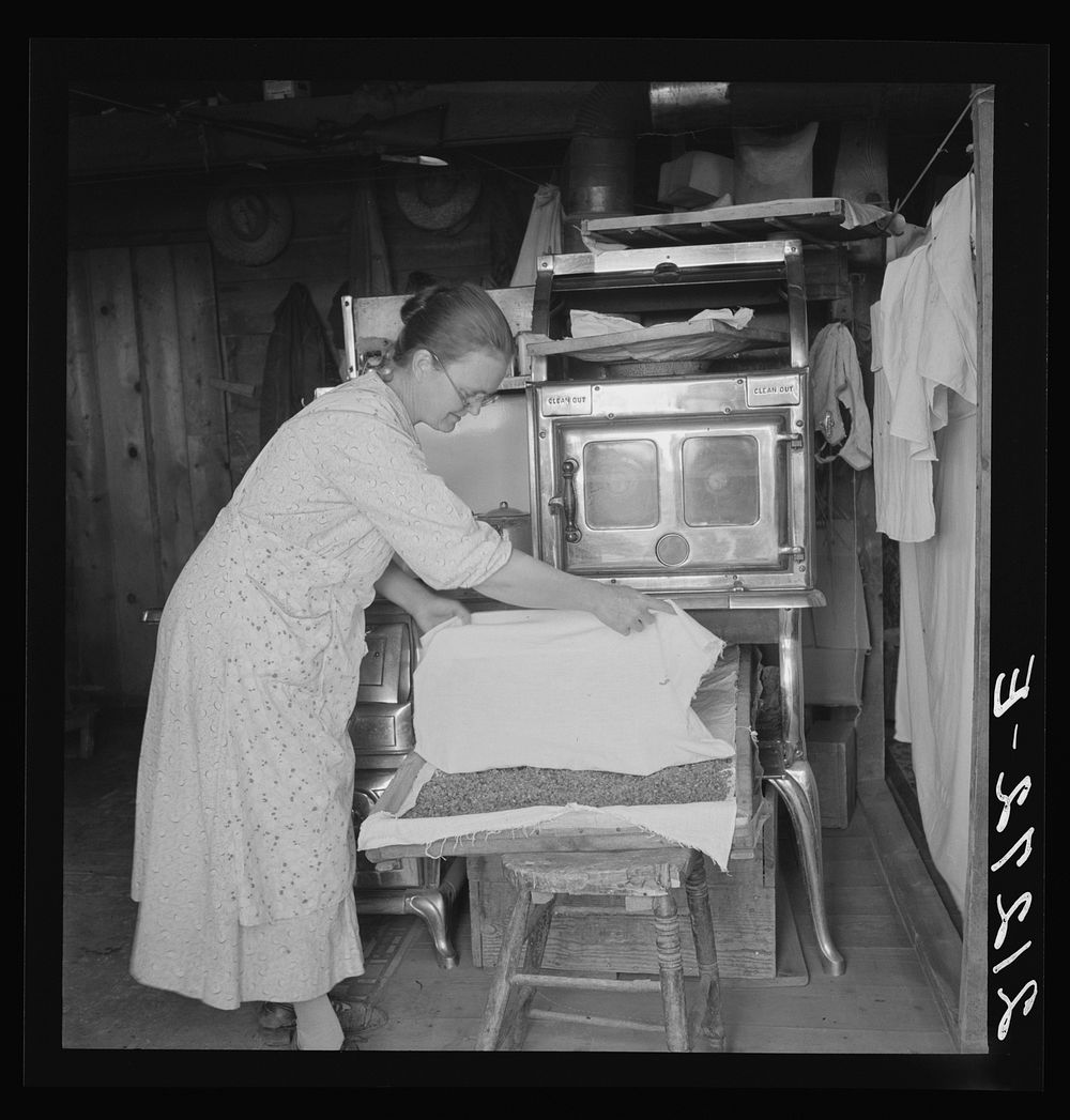 [Untitled photo, possibly related to: Mrs. Hull drying corn. She hopes to sell enough to help her son through Bible school.…