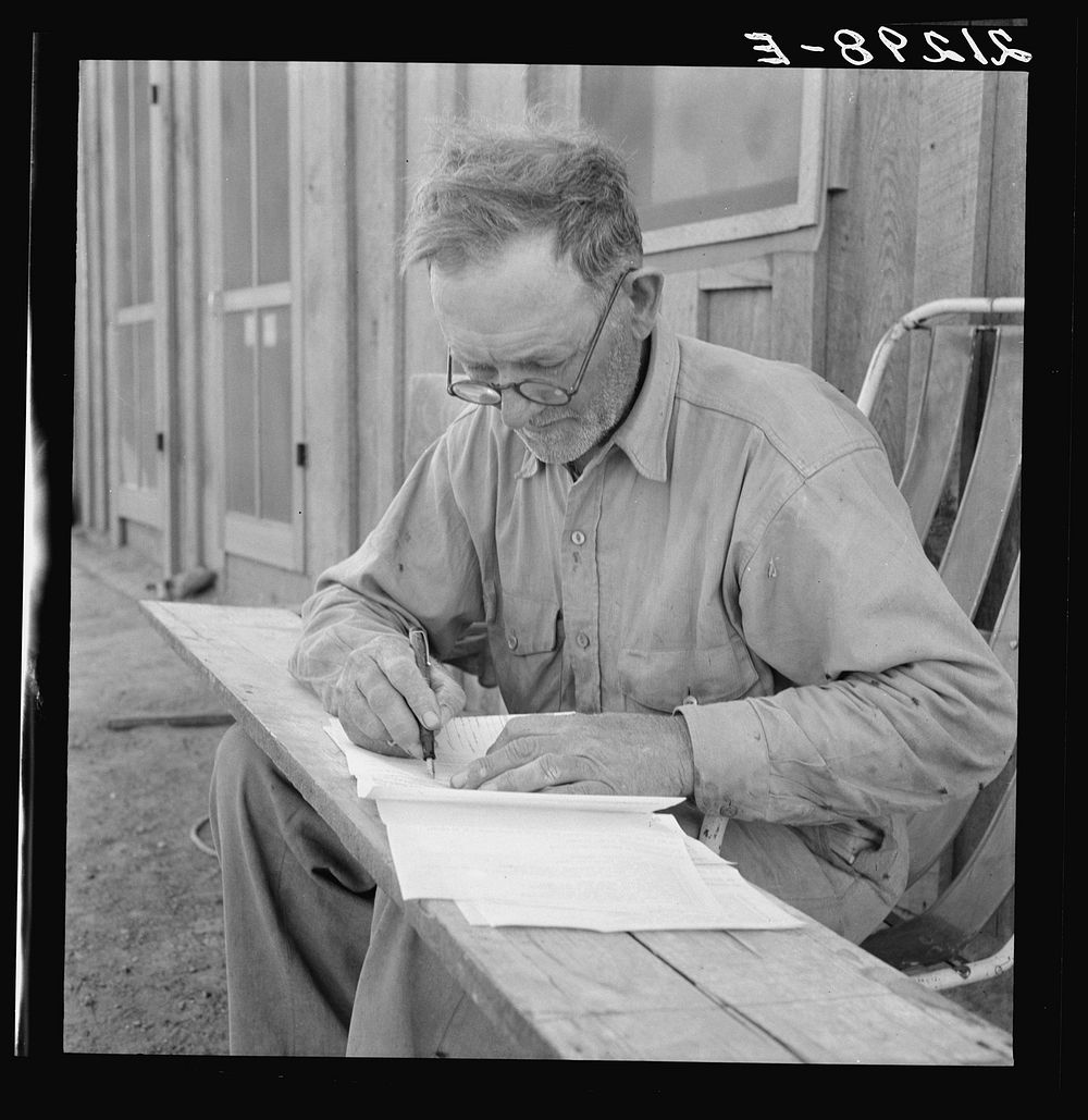 Oklahoma farmer, now living in Cow Hollow, is a FSA (Farm Security Administration) borrower. Seen here signing his chattel…