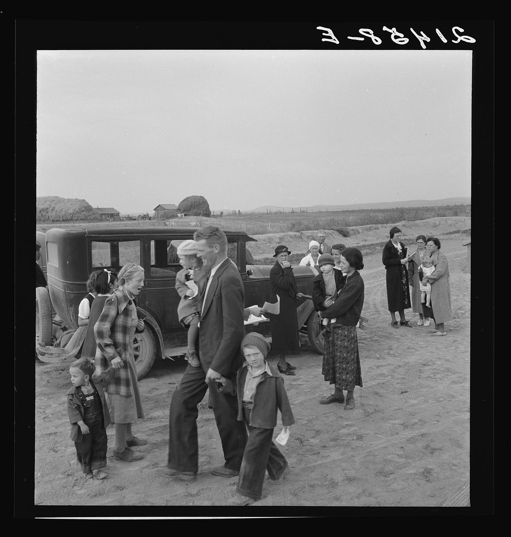 [Untitled photo, possibly related to: Congregation leaving after services. Preacher in doorway. Dead Ox Flat, Malheur…