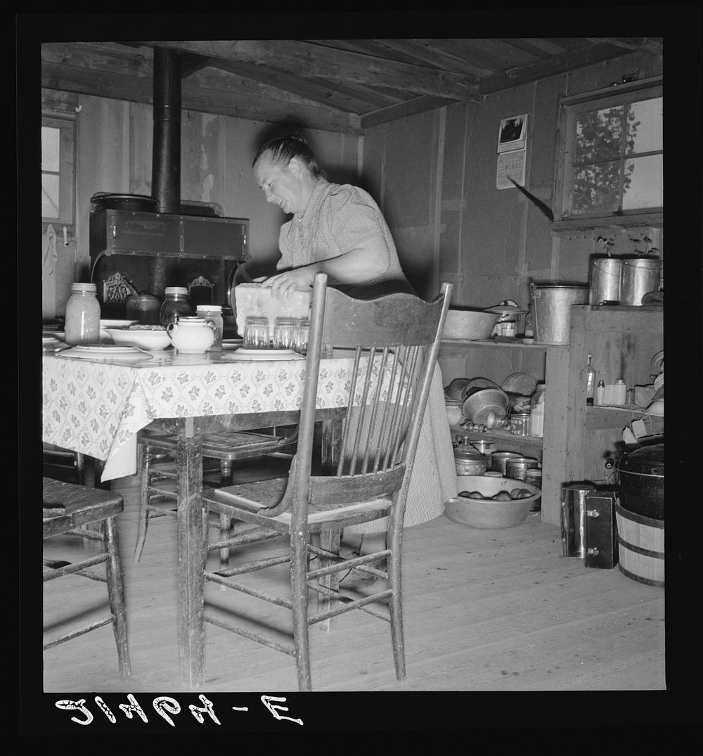 Mrs. Wardlow bakes her own bread in her dugout house. Dead Ox Flat, Malheur County, Oregon. Sourced from the Library of…