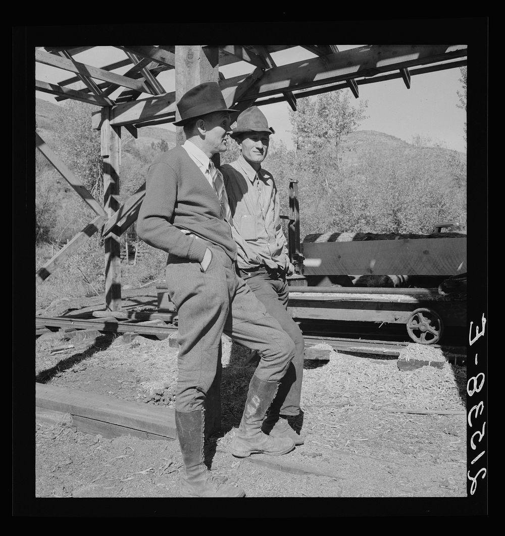 [Untitled photo, possibly related to: Men working in mill. Ola self-help sawmill co-op. Gem County, Idaho. Man in rear…